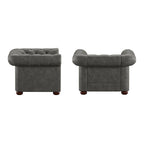 Fauteuil Chesterfield capitonné à accoudoirs volutes